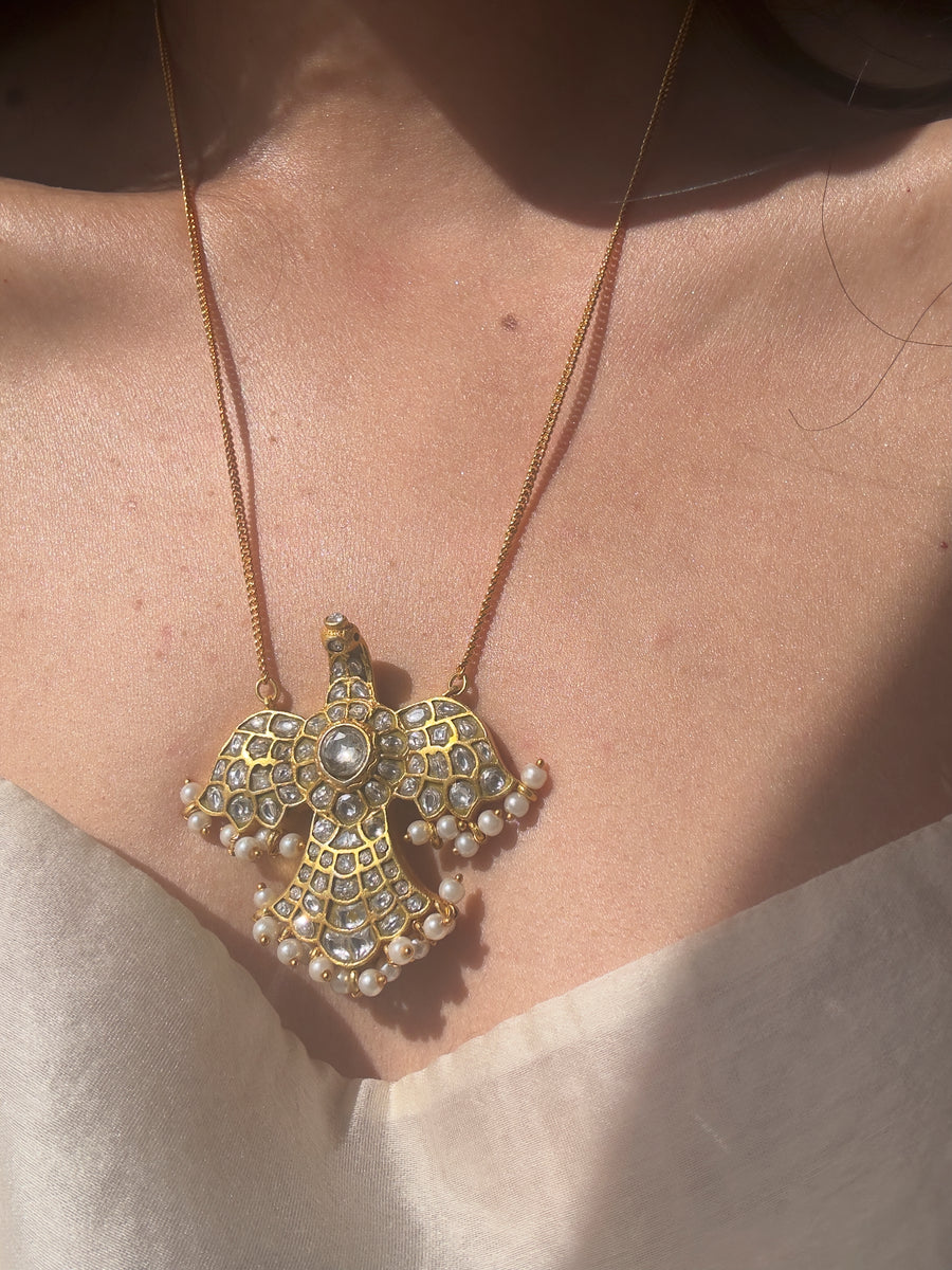 Close-up of the kundan bird pendant with pearl drops